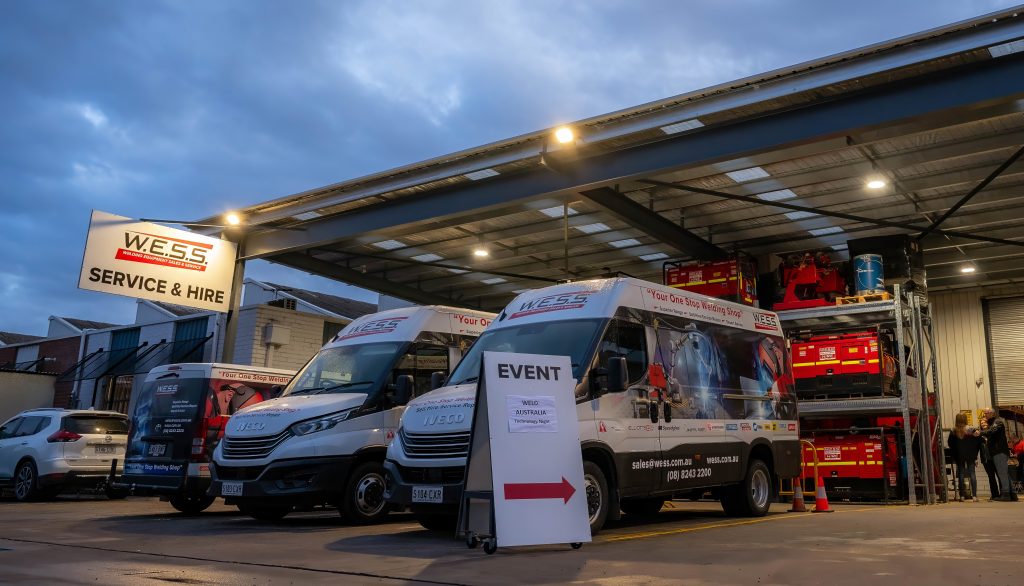 W.E.S.S. Service and Hire facility with branded vans parked in front, showcasing an event setup in Adelaide.