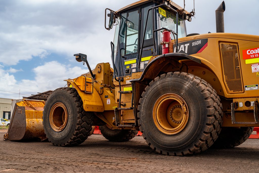 Front view of a CAT 950H loader in Whyalla with an industrial backdrop.