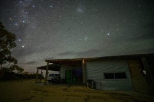 Star-filled night sky above a corrugated iron cabin in the Murraylands, South Australia.