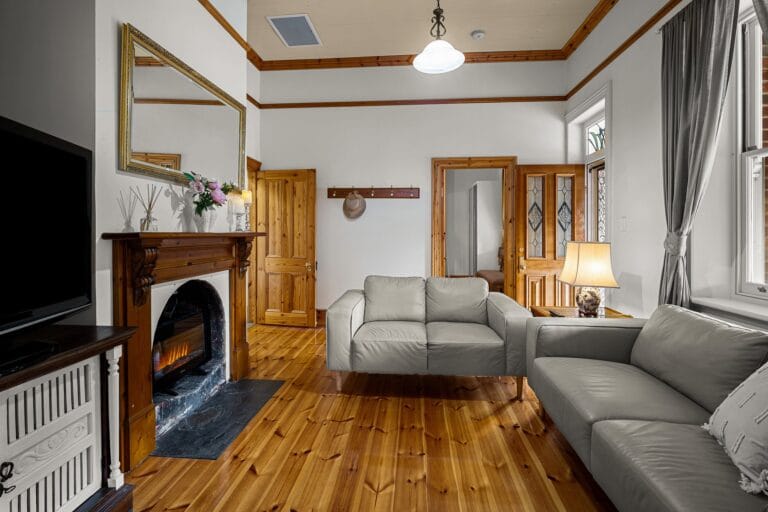 Front living room with fireplace and warm timber character.